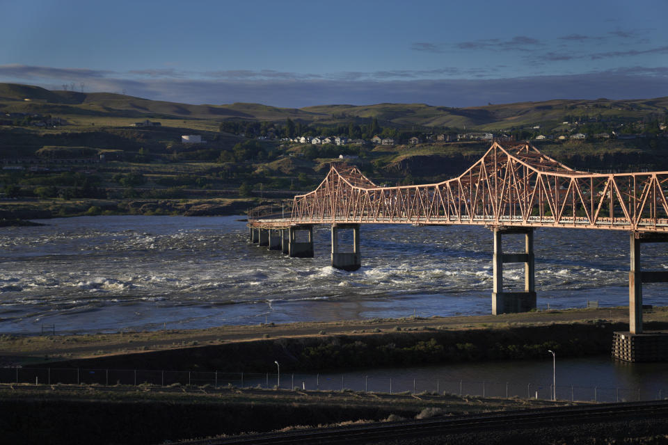 Water from the Columbia River churns below The Dalles bridge near The Dalles Dam, crossing the Washington and Oregon state line, on Sunday, June 19, 2022. The river is threatened by industrialization, climate change and pollution. (AP Photo/Jessie Wardarski)