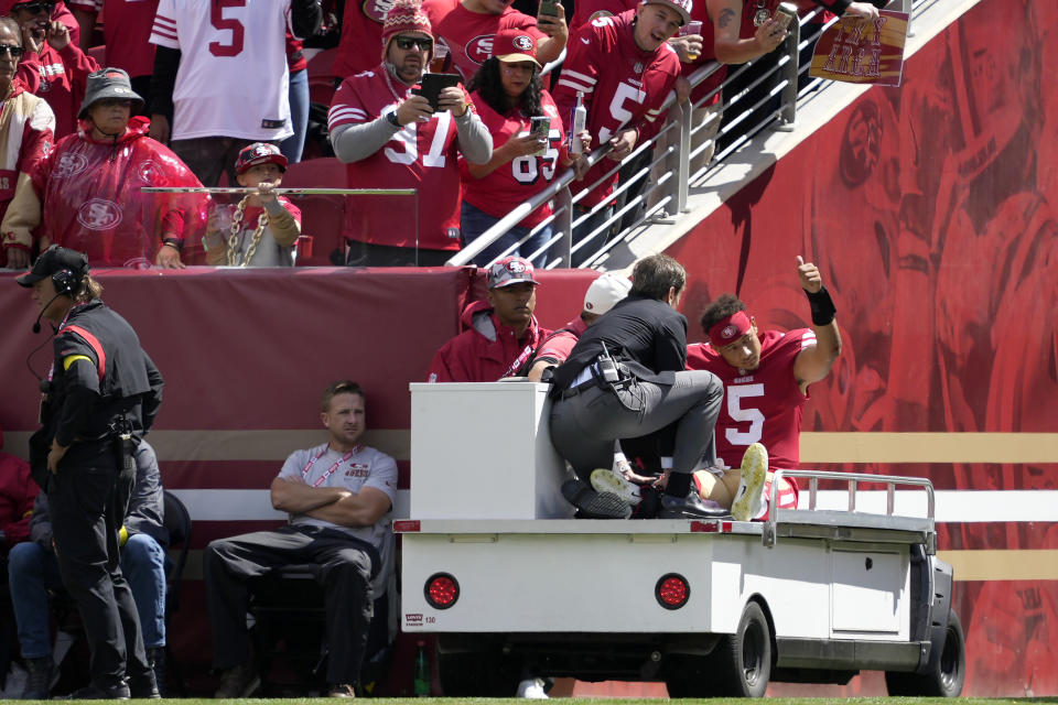 San Francisco 49ers quarterback Trey Lance (5) gestures while being carted off the field during the first half of an NFL football game against the Seattle Seahawks in Santa Clara, Calif., Sunday, Sept. 18, 2022. (AP Photo/Tony Avelar)