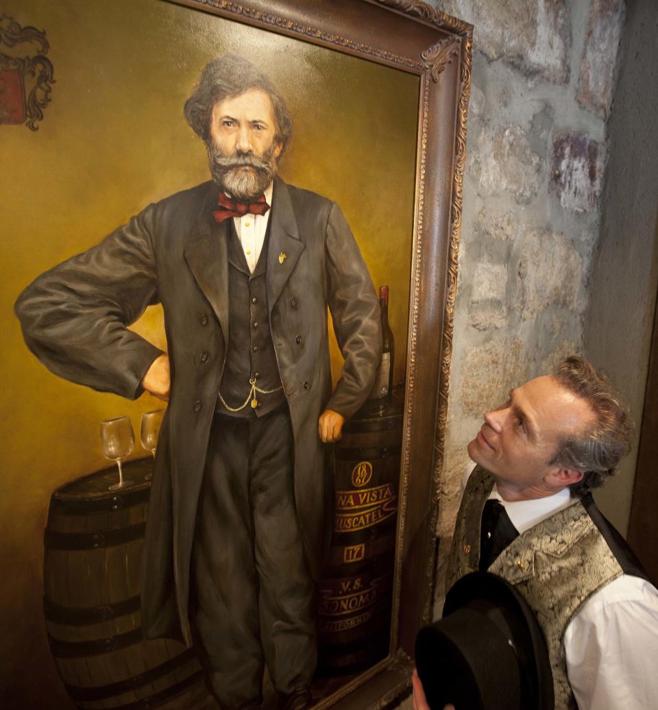 In this photo taken Friday, Aug. 31, 2012, Jean-Charles Boisset, looks up at a portrait of Agoston Haraszthy, the founder of Buena Vista Winery and "Count of Buena Vista" at the winery in Sonoma, Calif. Many people think the California wine world came of age in 1976 after a famous tasting in Paris put the Golden State’s vintages on the world map. But for Boisset, new owner of the state’s oldest commercial winery, the state’s fine wine making traditions started a century before that. That’s why the Burgundian is building the future of 155-year-old Buena Vista Winery, a landmark known as the birthplace of California wine, on its past. He plans to make wines in September in the stately stone buildings and old wine caves for the first time in two decades. (AP Photo/Eric Risberg)