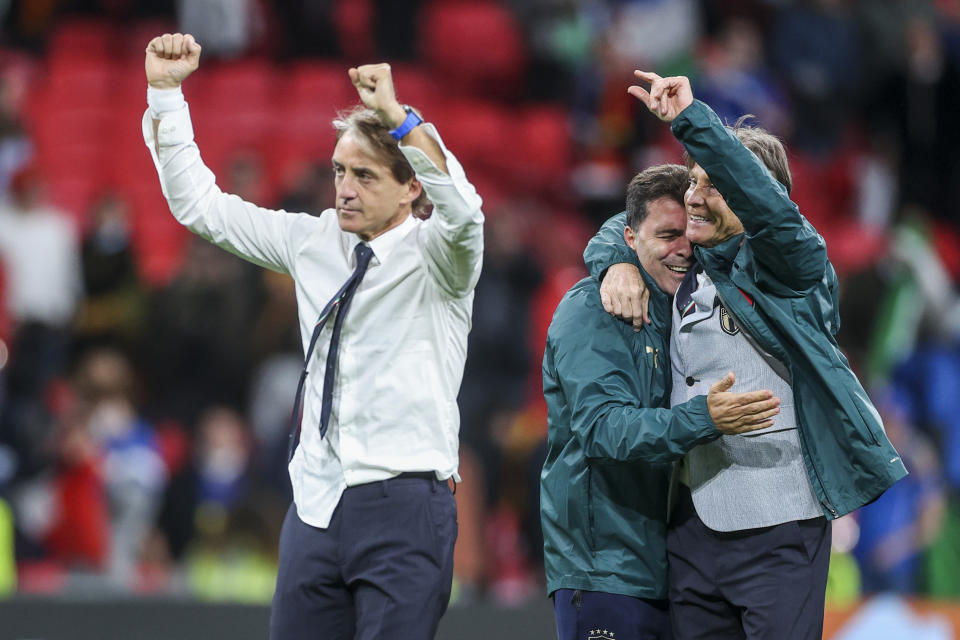 Italy's manager Roberto Mancini, left, celebrates after winning the Euro 2020 soccer championship semifinal match against Spain at Wembley stadium in London, England, Tuesday, July 6, 2021. (Carl Recine/Pool Photo via AP)