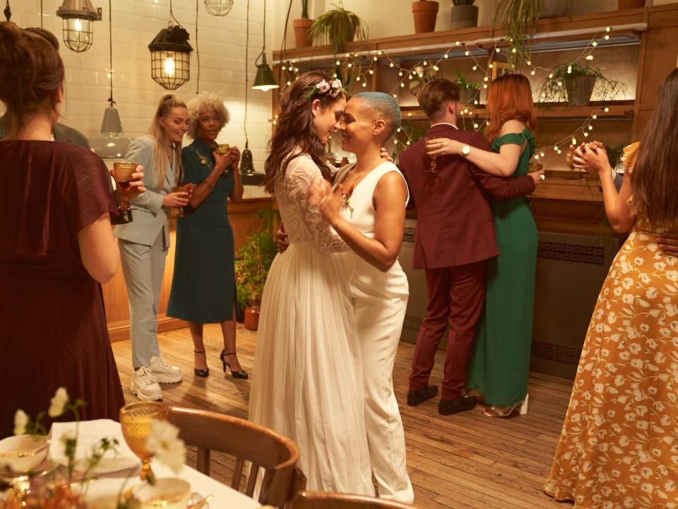 Two brides dance together at their intimate wedding.