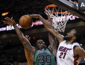 Miami Heat's Ronny Turiaf (21) blocks a shot by Boston Celtics' Brandon Bass (30) during the second half of Game 1 in their NBA basketball Eastern Conference finals playoffs series, Monday May, 28, 2012, in Miami. (AP Photo/Lynne Sladky)