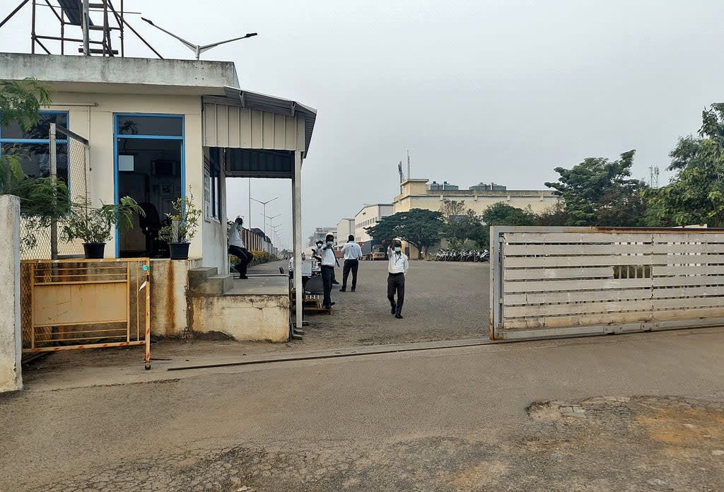 Private security guards stand at the entrance of a closed plant of Foxconn India (Reuters)