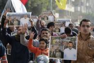 Supporters of the Muslim Brotherhood and ousted Egyptian President Mohamed Mursi protest against the military and interior ministry, while making the four-finger Rabaa gesture, at Nasr City district in Cairo January 3, 2014. The "Rabaa" or "four" gesture is in reference to the police clearing of the Rabaa al-Adawiya protest camp on August 14, 2013. (REUTERS/Mohamed Abd El Ghany)