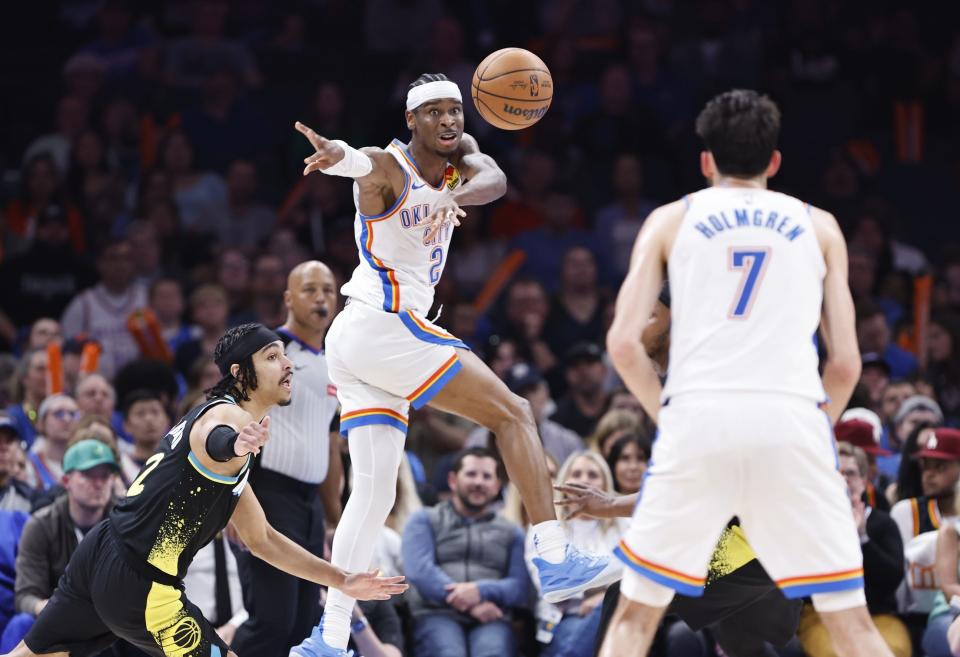 Mar 12, 2024; Oklahoma City, Oklahoma, USA; Oklahoma City Thunder guard Shai Gilgeous-Alexander (2) passes the ball to forward Chet Holmgren (7) on a play against the Indiana Pacers during the second half at Paycom Center. Mandatory Credit: Alonzo Adams-USA TODAY Sports