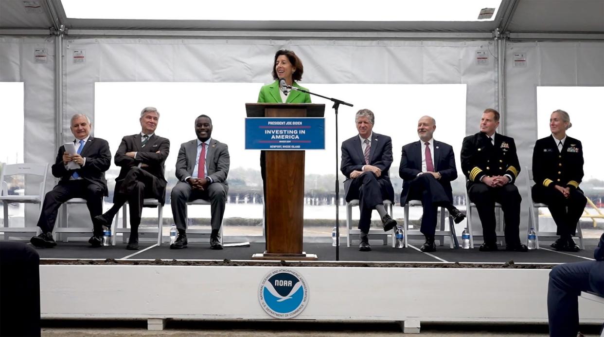 U.S. Secretary of Commerce Gina Raimondo takes a turn at the podium as officials break ground at Naval Station Newport (RI) on a new facility that will serve as the future home of the NOAA Marine Operations Center-Atlantic). Behind her, from left, are Senators Jack Reed and Sheldon Whitehouse, Rep. Gabe Amo, Raimondo, Gov. Dan McKee, NOAA Administrator Rick Spinrad; Capt. Henry M. Roenke IV, commanding officer of Naval Station Newport, and Rear Admiral Nancy Hann, director, NOAA corps and office, and marine and aviation operations.