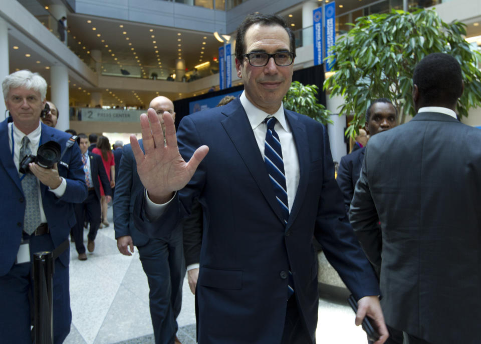 Treasury Secretary Steven Mnuchin waves after attending the International Monetary and Financial Committee conference at the World Bank/IMF Spring Meetings in Washington, Saturday, April 13, 2019. (AP Photo/Jose Luis Magana)