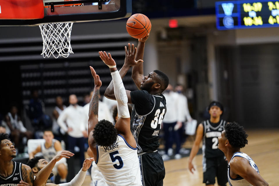 Georgetown's Qudus Wahab (34) goes up for a shot against Villanova's Justin Moore (5) during the second half of an NCAA college basketball game, Sunday, Feb. 7, 2021, in Villanova, Pa. (AP Photo/Matt Slocum)