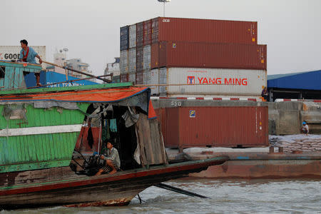 A boat rides past Asia World port at the Hlaing river in Yangon May 14, 2016. REUTERS/Soe Zeya Tun