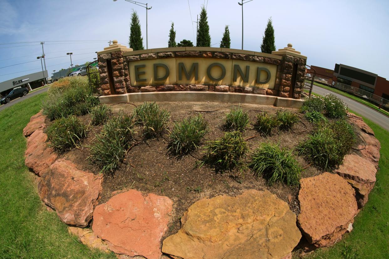 A sign welcomes people to Edmond on July 17 in the median on Broadway.