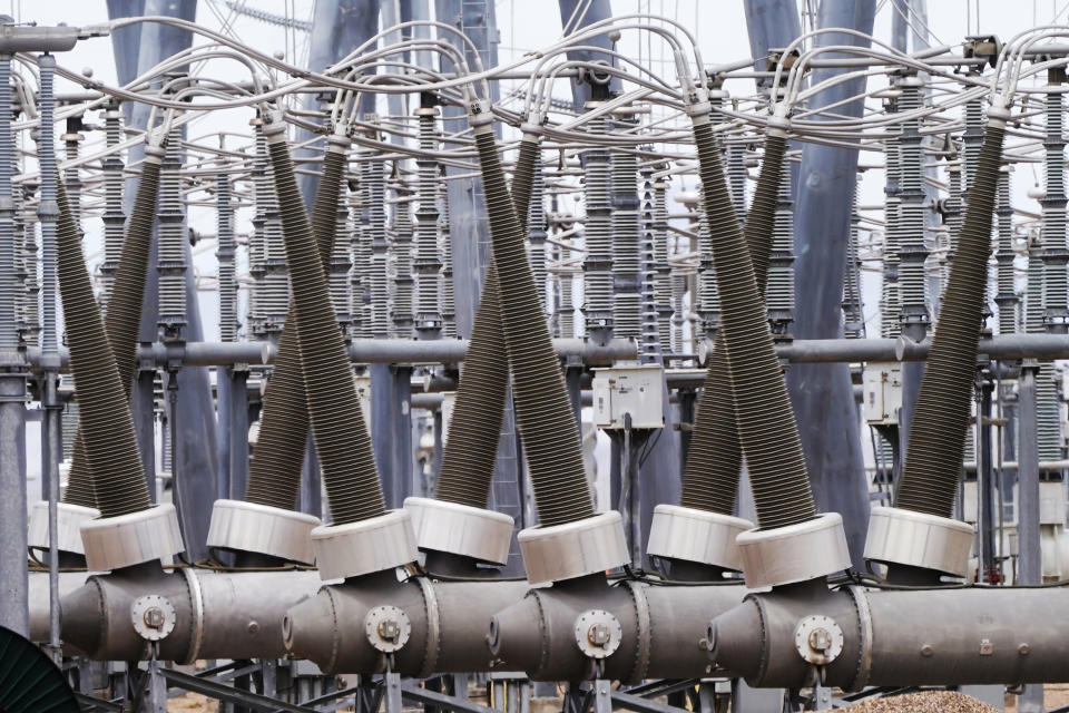 Coal-fired electricity is transmitted through a substation at Intermountain Power Plant on Wednesday, June 22, 2022, in Delta, Utah. In three years, the power lines will start being used to transport power generated with hydrogen to consumers in California and elsewhere. (AP Photo/Rick Bowmer)