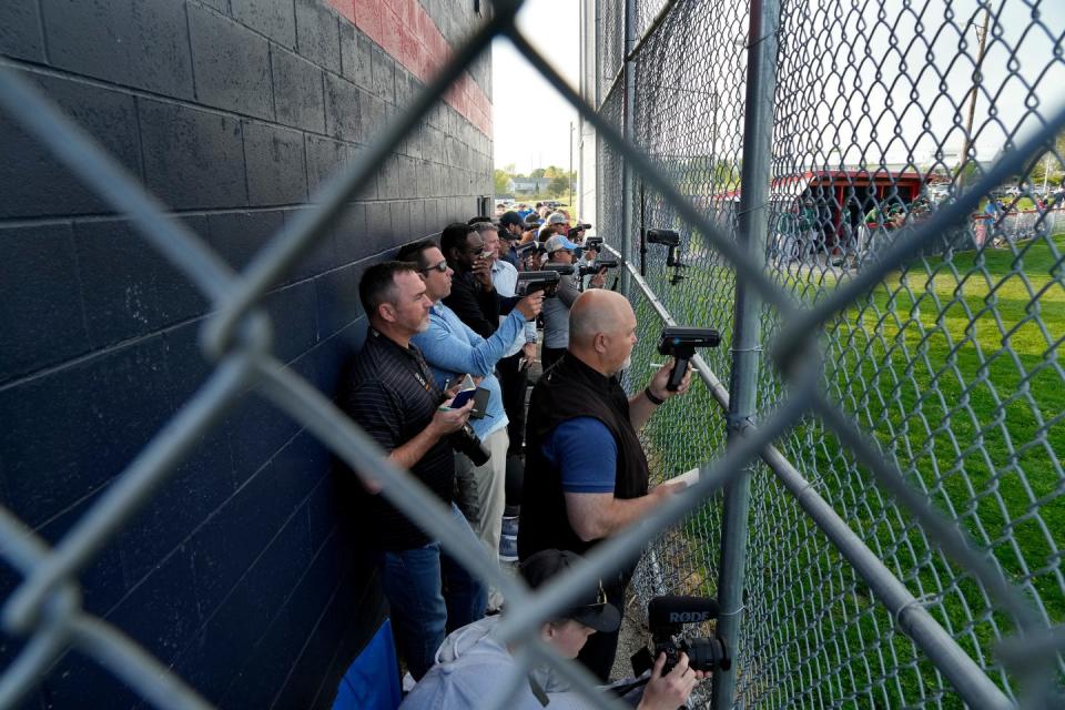 Scouts squeeze in behind home plate and use their radar guns to clock the pitches of Hendricken's Alex Clemmey on May 11.