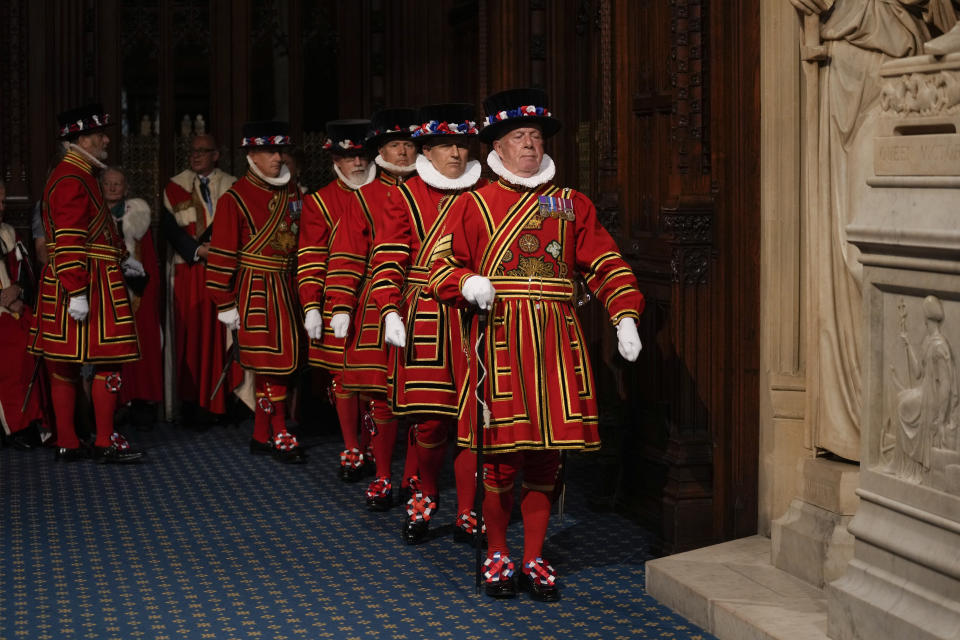 Yeomen Warders arrive for the ceremonial search of the Palace of Westminster prior to the State Opening of Parliament in London, Tuesday, May 10, 2022. Buckingham Palace said Queen Elizabeth II will not attend the opening of Parliament on Tuesday amid ongoing mobility issues. (AP Photo/Alastair Grant, Pool)