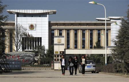 People walk outside a labour camp in Kunming, Yunnan province, November 22, 2013. REUTERS/John Rudwich