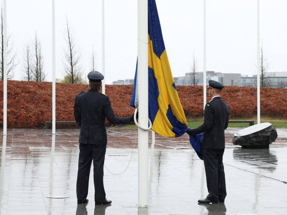 A Swedish flag is raised outside NATO's office in Brussels on Monday, March 11, 2024. (Reuters - image credit)