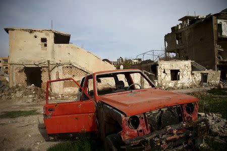 A damaged vehicle is seen in the rebel-controlled area of Jobar, a suburb of Damascus, Syria March 2, 2016. REUTERS/Bassam Khabieh