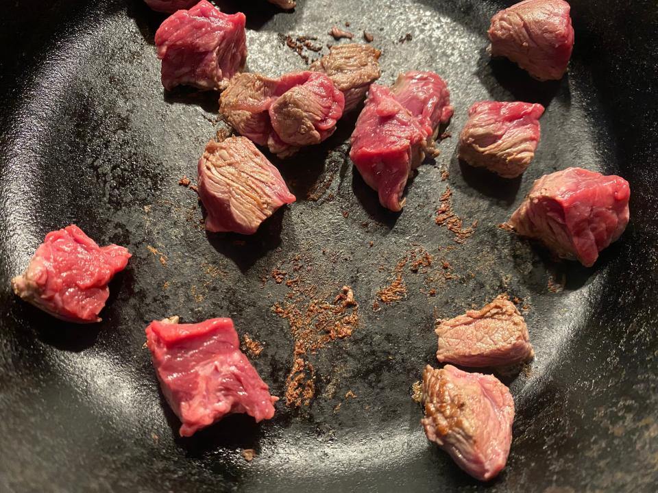 Seasoned beef in a pan.