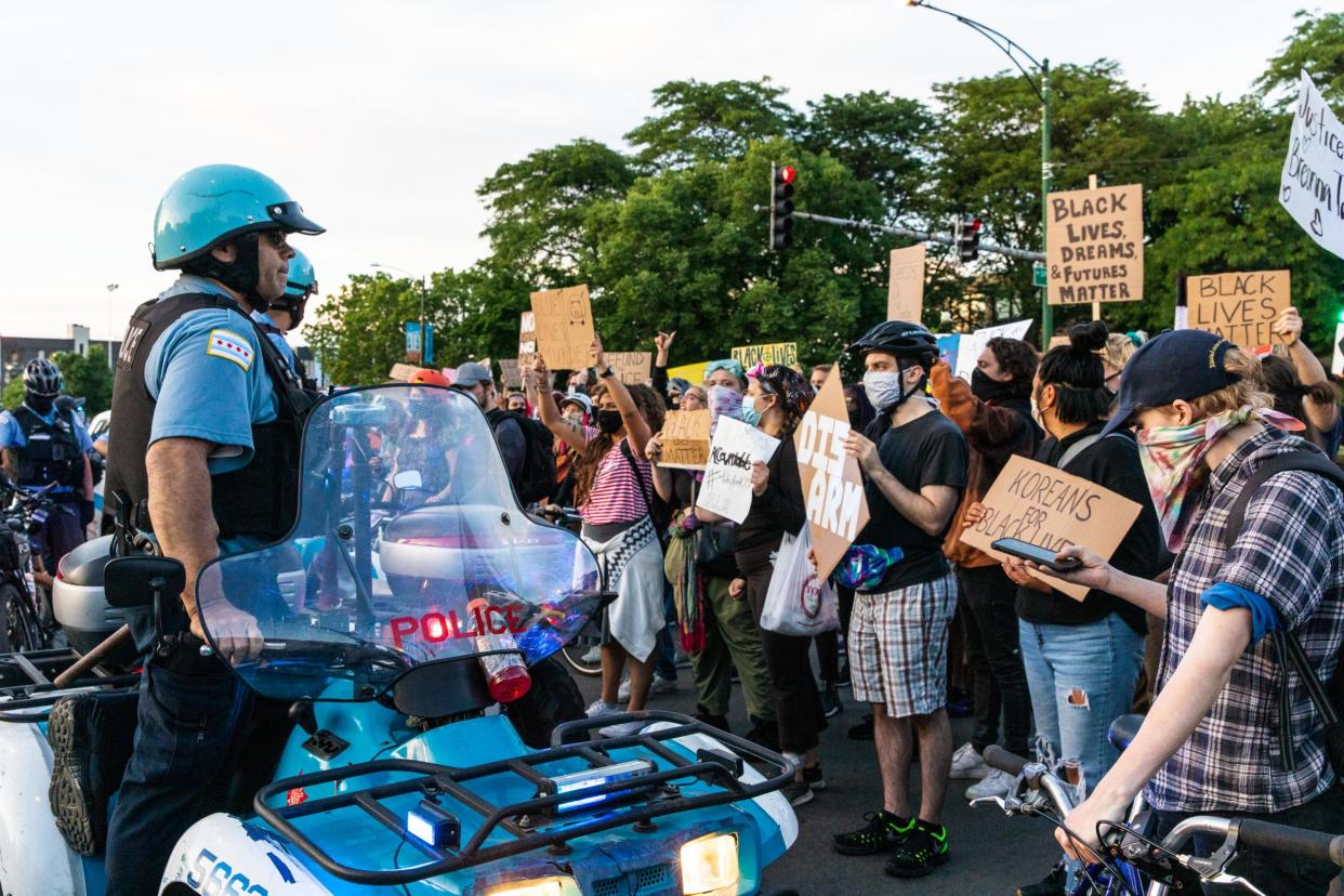 Protesters chant and wave signs at the Chicago Police Department during a protest: (2020 Getty Images)