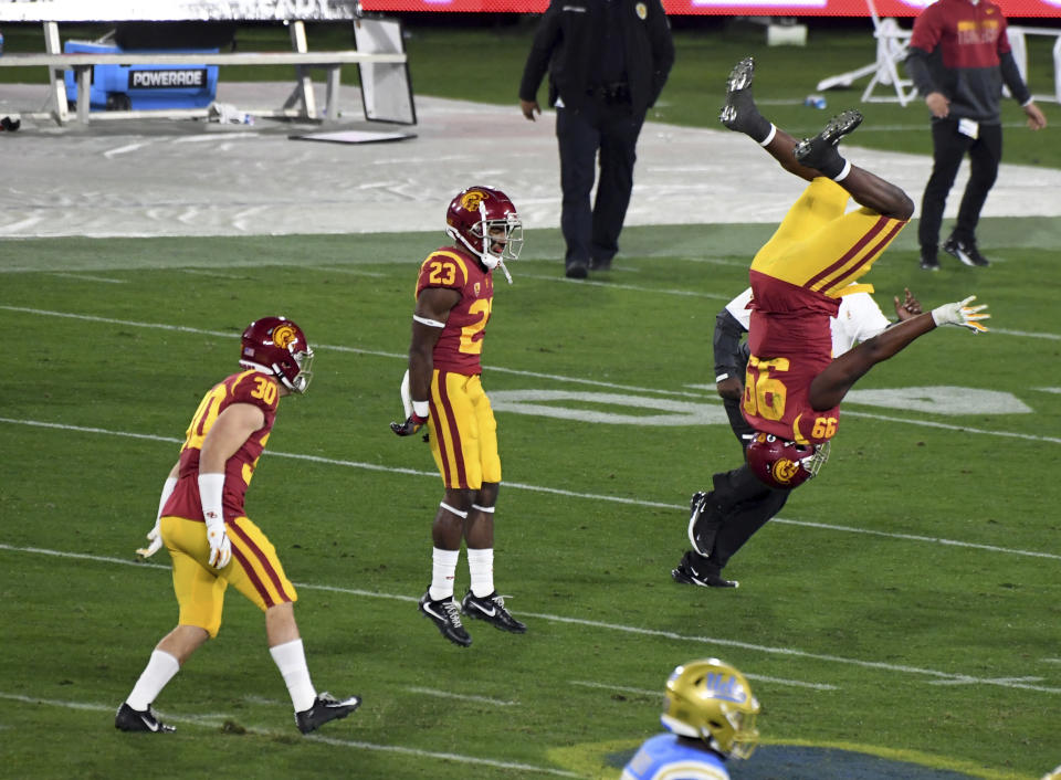 Southern California players, including Drake Jackson (99), celebrate a win over UCLA in an NCAA college football game Saturday, Dec. 12, 2020, in Pasadena, Calif. (Keith Birmingham/The Orange County Register via AP)