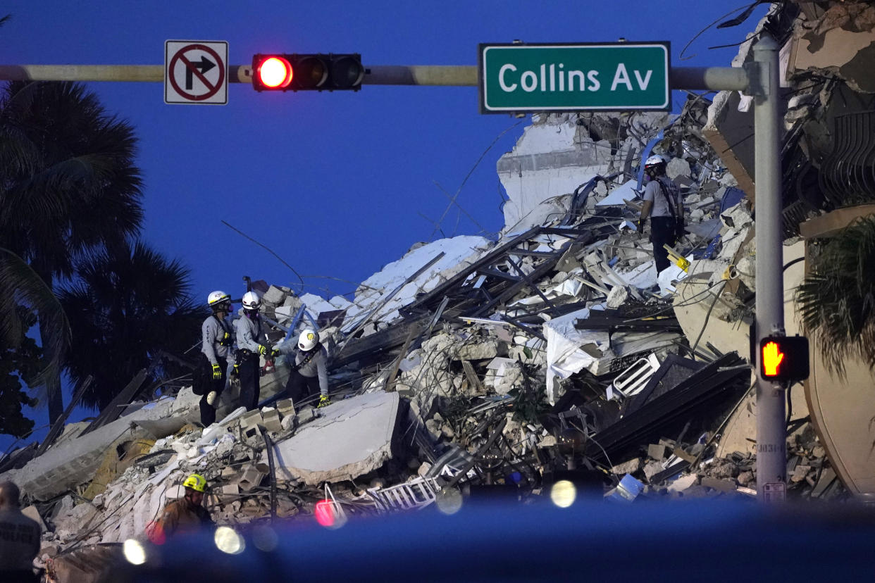 Rescue workers look through the rubble where a wing of a 12-story beachfront condo building collapsed, Thursday, June 24, 2021, in the Surfside area of Miami. (AP Photo/Lynne Sladky)