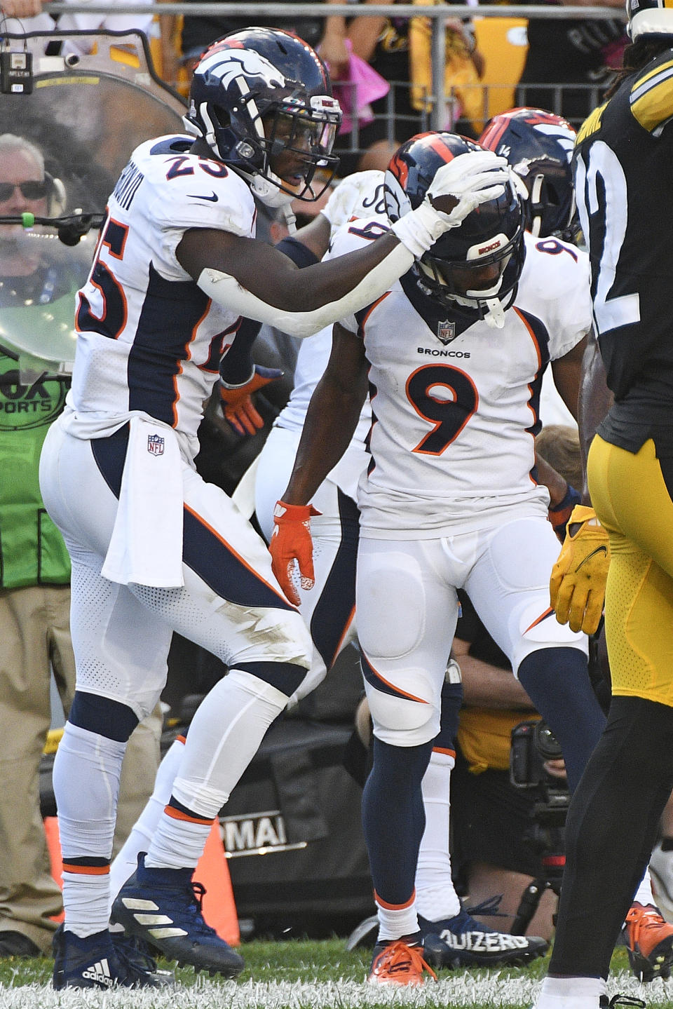 Denver Broncos wide receiver Kendall Hinton (9) celebrates with Melvin Gordon (25) after scoring a touchdown on a pass from quarterback Teddy Bridgewater during the second half of an NFL football game against the Pittsburgh Steelers in Pittsburgh, Sunday, Oct. 10, 2021. (AP Photo/Don Wright)