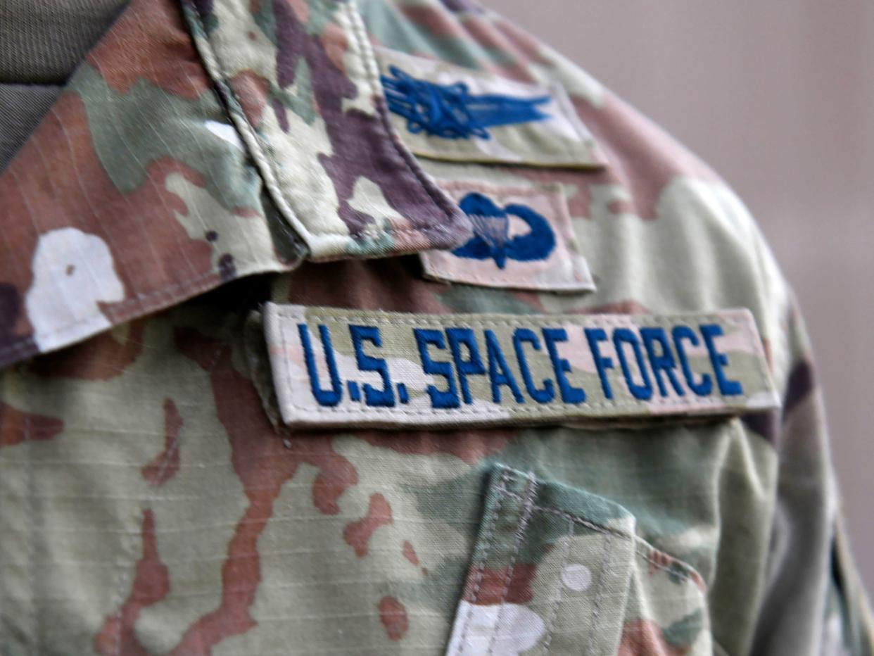  In this photo released by the U.S. Air Force, Capt. Ryan Vickers stands for a photo to display his new service tapes after taking his oath of office to transfer from the U.S. Air Force to the U.S. Space Force at Al-Udeid Air Base, Qatar, Tuesday, Sept. 1, 2020