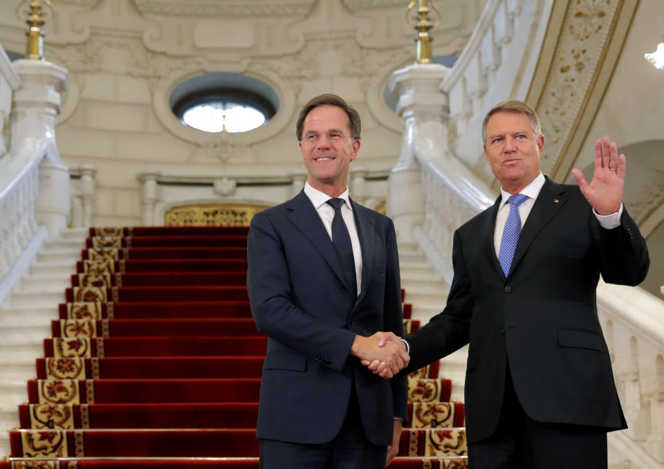 Dutch Prime Minister Mark Rutte, left, shakes hands with Romanian President Klaus Iohannis at the Cotroceni Presidential Palace in Bucharest, Romania, Wednesday, Sept. 12, 2018. Rutte is on a one day official visit to Romania.(AP Photo/Vadim Ghirda)