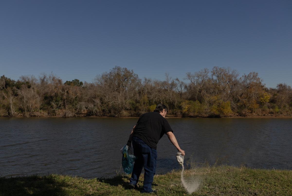 Donald Green's stepson Jerry Barker spreads Green's and Green's dog's ashes, at the backyard of Green's old home in Freeport during a celebration of life, on Dec. 16, 2023.