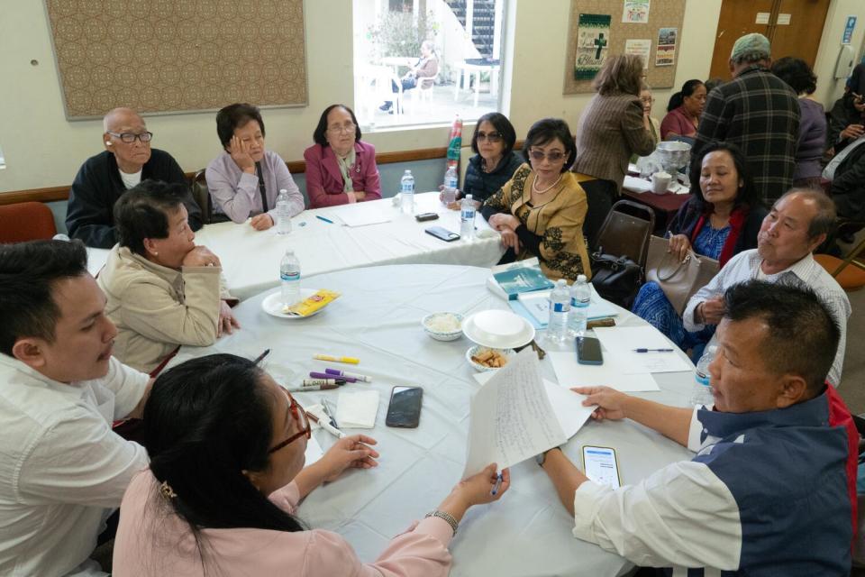 Members of the Long Beach chapter of the Cambodian National Rescue Party discuss strategies for their pro-democracy efforts.