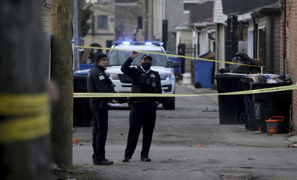Police work at the scene of a fatal shooting of a 13-year-old boy by a Chicago Police officer on Monday, March 29, 2021 in Chicago. Calls for the release of body camera video of the fatal shooting of the 13-year-old boy by a Chicago Police officer are growing louder both within and outside the department. As the agency that investigates police shootings says it is investigating if there is a legal way to release the video of Monday's shooting of Adam Toledo, Police Superintendent David Brown and Mayor Lori Lightfoot both say it should be released. (Antonio Perez/Chicago Tribune via AP)