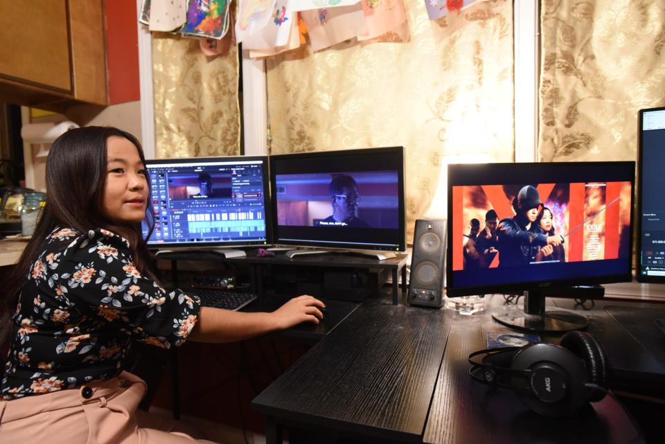 "Exile" lead actor, editor, and assistant director Nuam Boih, pictured in the makeshift editing bay at her cousin's home in Lansing.