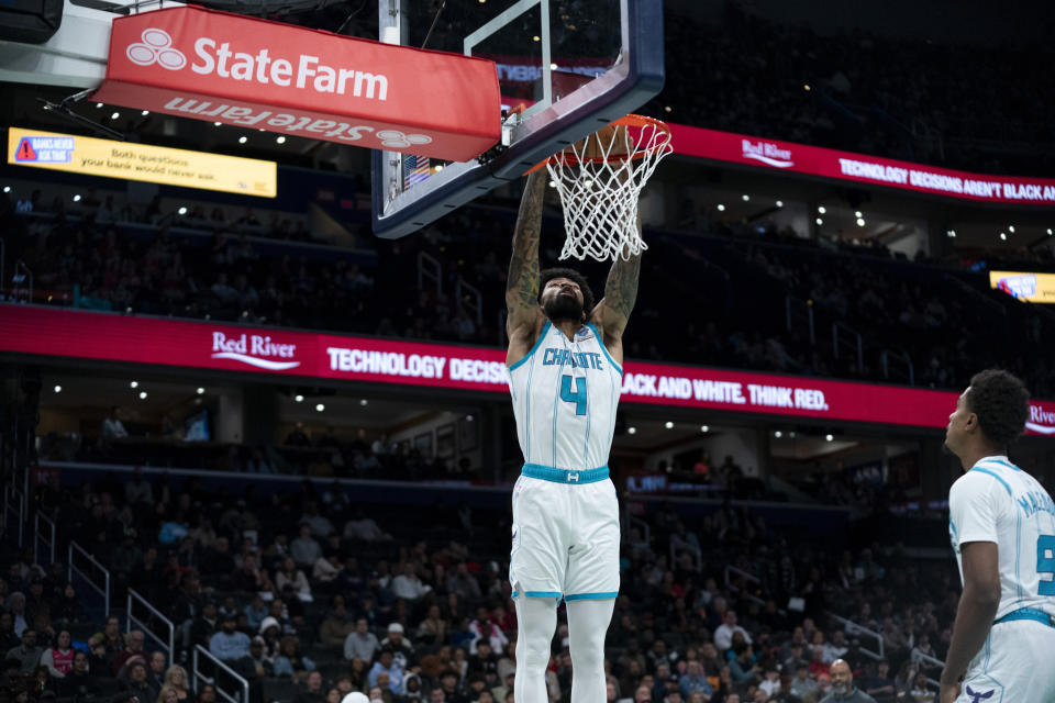 Charlotte Hornets center Nick Richards (4) dunks during the first half of an NBA basketball game against the Washington Wizards, Friday, Nov. 10, 2023, in Washington. (AP Photo/Stephanie Scarbrough)
