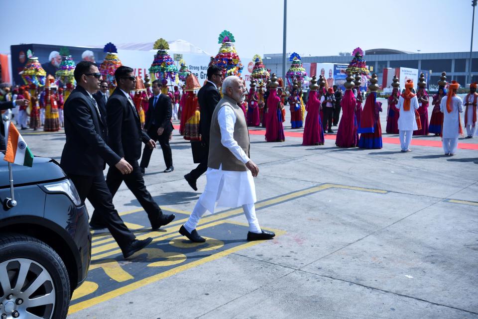 India's Prime Minister Narendra Modi (R) arrives to greet US President Donald Trump and First Lady Melania Trump at Sardar Vallabhbhai Patel International Airport in Ahmedabad on February 24, 2020. (Photo by Mandel NGAN / AFP) (Photo by MANDEL NGAN/AFP via Getty Images)