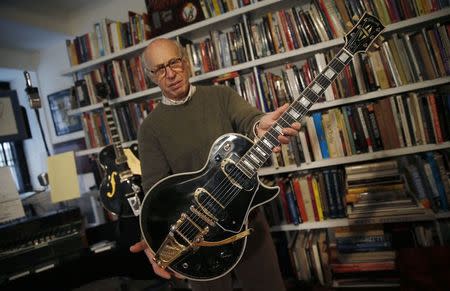 Guernsey's Auctions President Arlan Ettinger holds the Les Paul guitar known as "Black Beauty", which will go up for auction next month, in New York January 29, 2015. REUTERS/Mike Segar