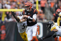 Cincinnati Bengals quarterback Joe Burrow (9) runs against Pittsburgh Steelers defensive tackle Montravius Adams (57) during the second half of an NFL football game, Sunday, Sept. 11, 2022, in Cincinnati. (AP Photo/Jeff Dean)