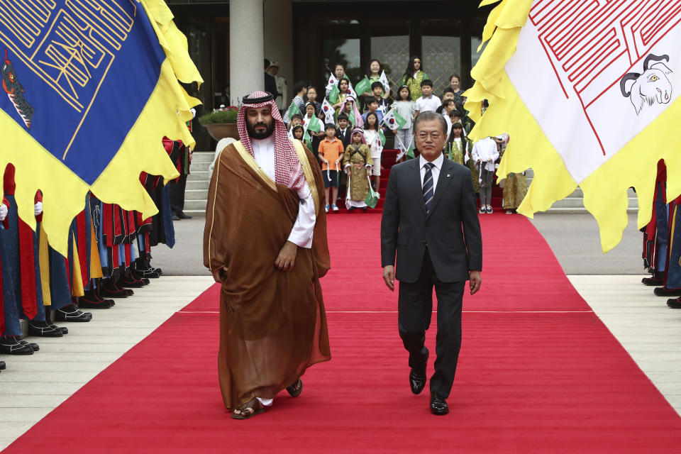 CORRECTS DAY South Korean President Moon Jae-in, right, and Saudi Crown Prince Mohammed bin Salman view an honor guard during a welcoming ceremony at the presidential Blue House, Wednesday, June 26, 2019, in Seoul, South Korea. Bin Salman is visiting South Korea for two days - the first time by an heir to the throne of Saudi Arabia since 1998. (Chung Sung-Jun/Pool Photo via AP)