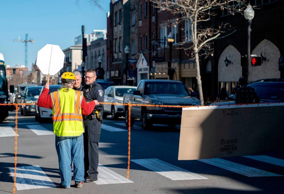 State College police talk to David Thomas Roberts as he blocks traffic on College Avenue at Allen Street on Saturday, Nov. 26, 2022.