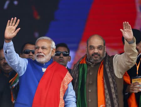 Indian Prime Minister Narendra Modi (L) and Amit Shah, the president of India's ruling Bharatiya Janata Party (BJP), wave to their supporters during a campaign rally ahead of state assembly elections at Ramlila ground in New Delhi, India, in this January 10, 2015 file photo. REUTERS/Anindito Mukherjee/Files