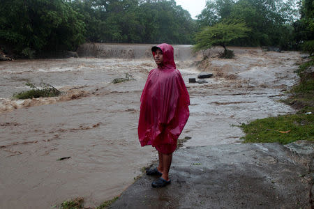 A resident stands on the shore of the Masachapa river, flooded by heavy rains by Tropical Storm Nate in the outskirts of Managua, Nicaragua October 5, 2017. REUTERS/Oswaldo Rivas