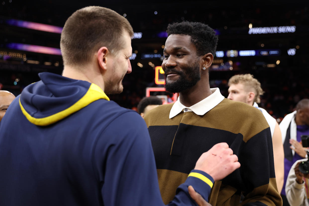 PHOENIX, ARIZONA - MAY 11: Nikola Jokic #15 of the Denver Nuggets greets Deandre Ayton #22 of the Phoenix Suns after the Nuggets defeated the Suns 125-100 in game six of the Western Conference Semifinal Playoffs at Footprint Center on May 11, 2023 in Phoenix, Arizona. NOTE TO USER: User expressly acknowledges and agrees that, by downloading and or using this photograph, User is consenting to the terms and conditions of the Getty Images License Agreement. (Photo by Christian Petersen/Getty Images)