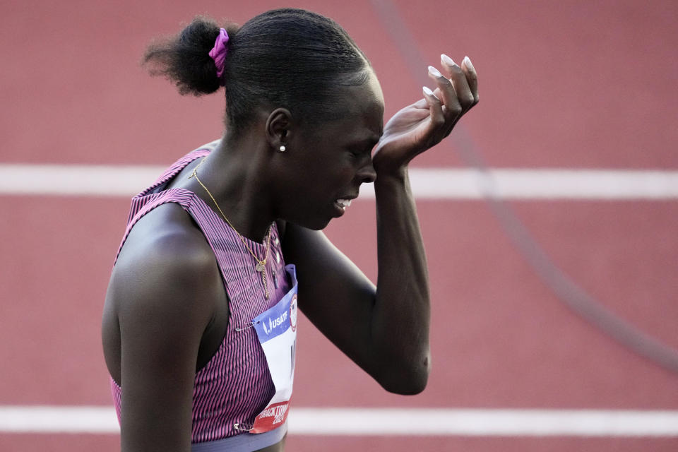 Athing Mu wipes her face after falling in the women's 800-meter final during the U.S. Track and Field Olympic Team Trials Monday, June 24, 2024, in Eugene, Ore. (AP Photo/Chris Carlson)