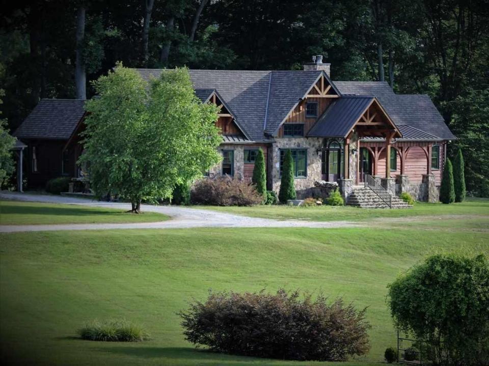 house with a lawn and tree in front in Alabama.