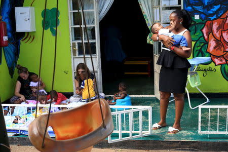 Local and foreign volunteers play with abandoned children at a home in Uganda's capital Kampala May 14, 2015. REUTERS/James Akena