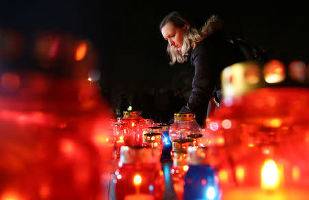 A Bosnian Croat woman lights a candle for the convicted general Slobodan Praljak, who killed himself seconds after the verdict in the U.N. war crimes tribunal in The Hague, in Mostar, Bosnia and Herzegovina November 29, 2017. REUTERS/Dado Ruvic