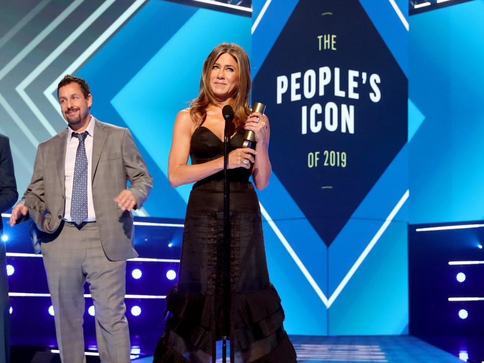 Adam Sandler and Jennifer Aniston, winner of the People's Icon award on stage during the 2019 E! People's Choice Awards held at the Barker Hangar on November 10, 2019