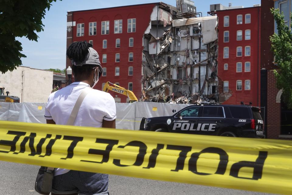 People view a six-story apartment building after it collapsed May 28, 2023, in Davenport, Iowa.