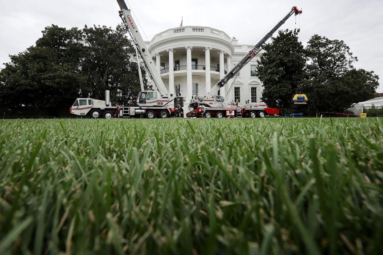 Construction cranes work to repair the South Portico steps as part of a large rennovation project at the White House: Getty Images