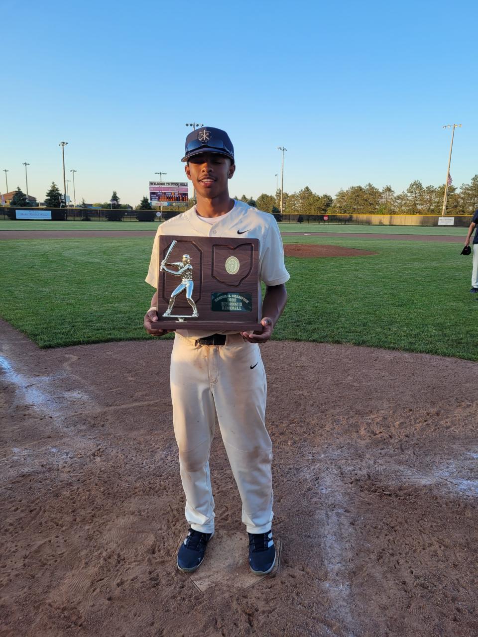 Archbishop Hoban sophomore baseball player Masud Jennings smiles with a Division II regional championship trophy after the Knights defeated Tiffin Columbian on June 3, 2022 in Bowling Green. Hoban plays in the state tournament this weekend.
