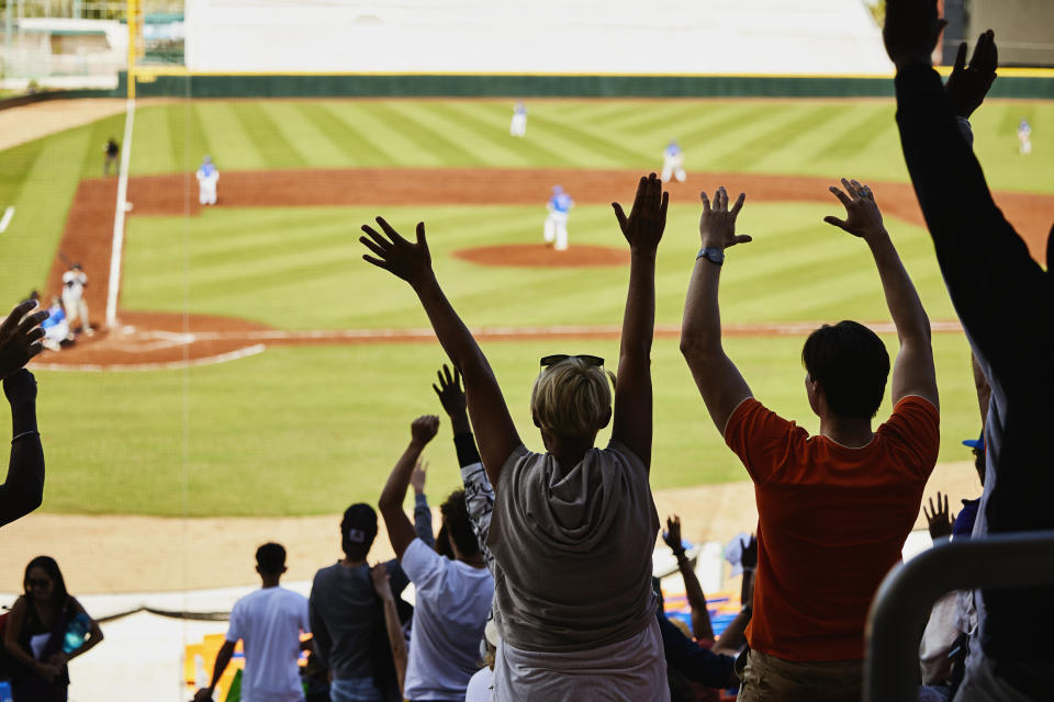 Fans watching a baseball game in a stadium