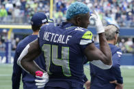 Seattle Seahawks wide receiver DK Metcalf stands on the sideline during the second half of an NFL football game against the Tennessee Titans, Sunday, Sept. 19, 2021, in Seattle. The Titans won 33-30 in overtime. (AP Photo/Elaine Thompson)